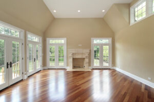 A large dining room with hardwood floors and patio doors.